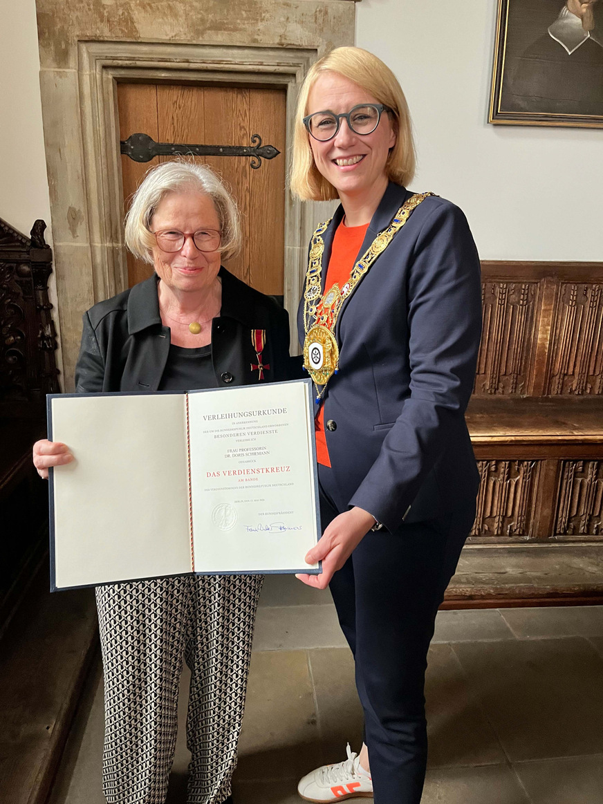 Frisch angesteckt: Prof. Dr. Doris Schiemann (links) hat das Verdienstkreuz am Bande des Verdienstordens der Bundesrepublik Deutschlands sowie die dazugehörige Verleihungsurkunde von Osnabrücks Oberbürgermeisterin Katharina Pötter im Osnabrücker Rathaus überreicht bekommen.