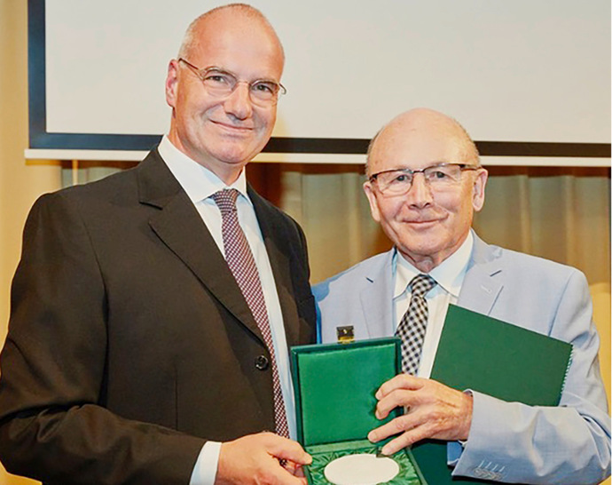 Erik Bodendieck (links) übergibt die Medaille an Prof. Dr. Klaus Scheuch (rechts)