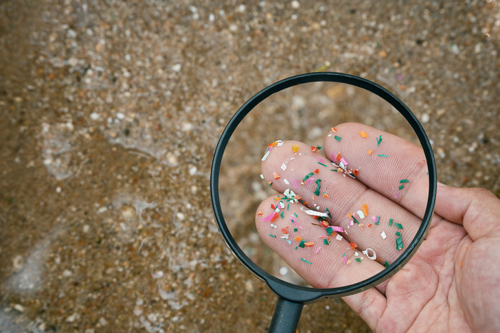 Close up side shot of microplastics lay on people hand. Concept of water pollution and global warming. Climate change idea. micro plastics concept in food and water or sea