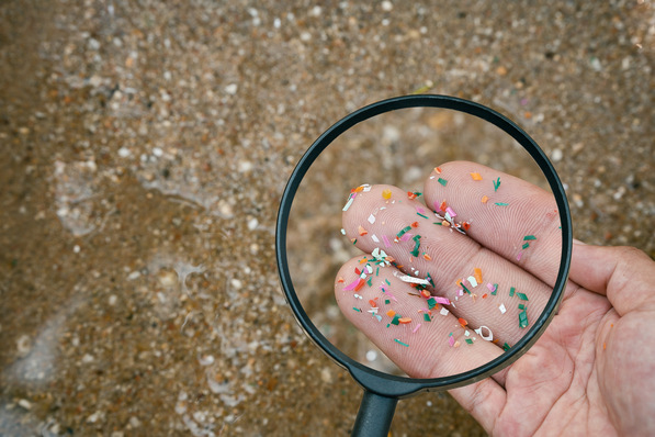 Close up side shot of microplastics lay on people hand. Concept of water pollution and global warming. Climate change idea. micro plastics concept in food and water or sea